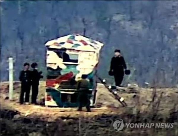 North Korean soldiers are spotted painting a guard post inside of the Demilitarized Zone separating the two Koreas on Nov. 24, 2023, as part of an apparent move to restore guard posts destroyed following a 2018 inter-Korean military agreement, in this photo provided by the South Korean defense ministry on Nov. 27. (PHOTO NOT FOR SALE) (Yonhap) 