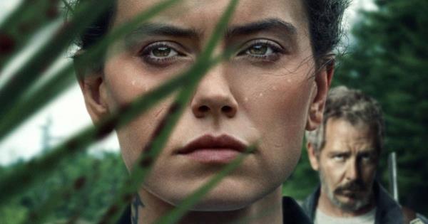 An upclose shot of Daisy Ridley and Ben Mendelsohn behing foliage in The Marsh King's Daughter