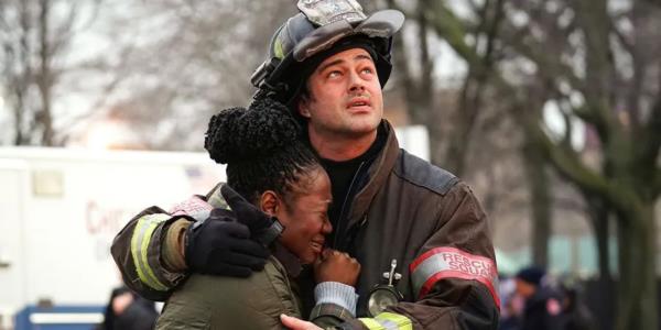 Taylor Kinney's character hugging someone in Chicago Fire