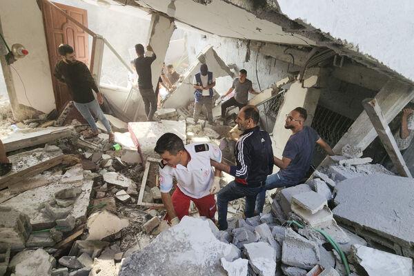 Palestinians look for survivors in the rubble of a destroyed building following an Israeli airstrike in Bureij refugee camp, Gaza Strip, Thursday, Nov. 2, 2023. (AP Photo/Hassan Eslaiah)