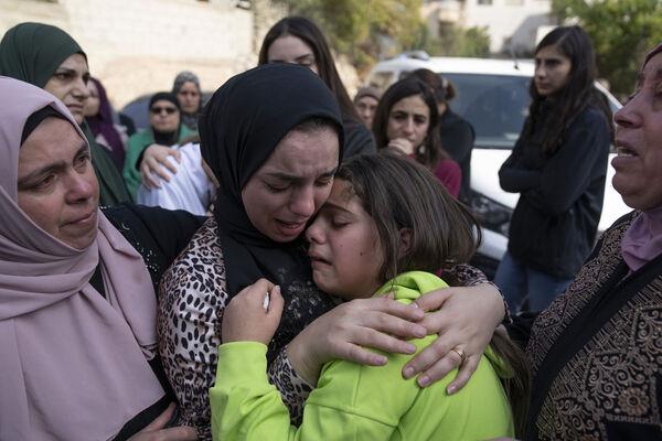 Women cry while they take the last look at the body of Ayham Shafe'e, 14, during his funeral in the West Bank city of Ramallah. Picture: AP Photo/Nasser Nasser