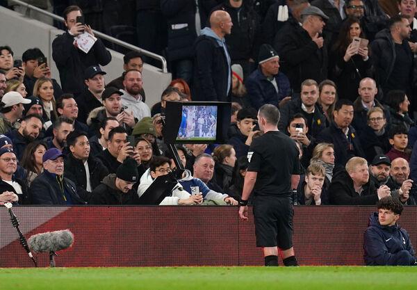 Referee Michael Oliver checks VAR for a possible penalty. Photo credit: John Walton/PA Wire.