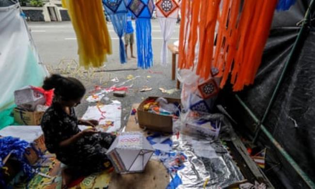 Sri Lankan children make paper lanterns during the Vesak full moon day in Colombo, Sri Lanka.