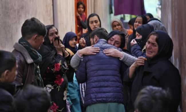 Afghan musician Nazir Amir Mohammed is hugged by a relative in Kabul in February 2022, as he prepares to leave for Iran
