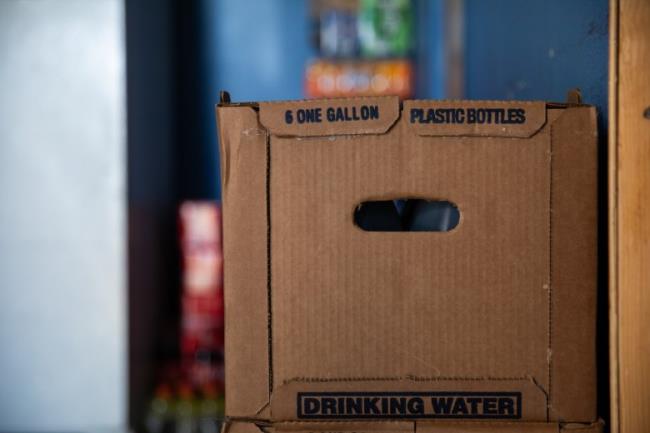 A crate with six gallons of water sits in the kitchen area of Entrika Zacariass home at Oasis Mobile Home Park in Coachella Valley on Aug. 23, 2023.