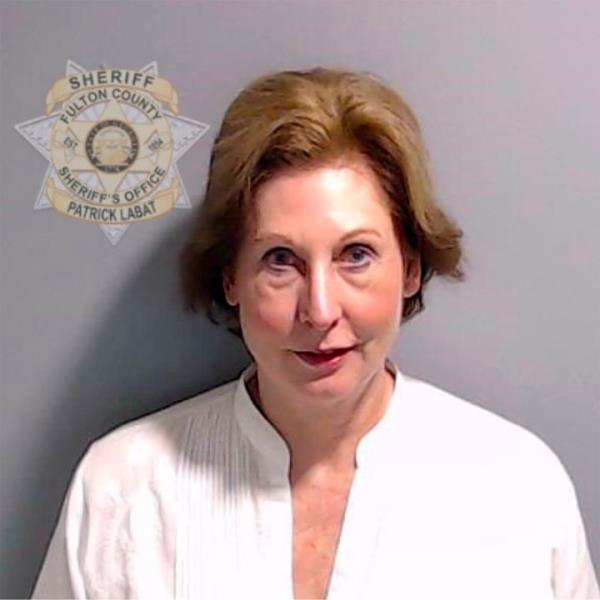 Sidney Powell turned herself into the Fulton County Sheriff's Office on Wednesday.
