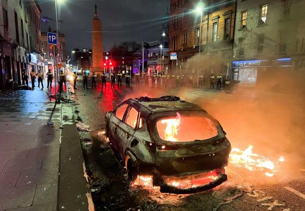 A car set on fire during the riot of November 23